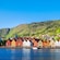 Waterfront buildings lining the shoreline in front of a large mountain range
